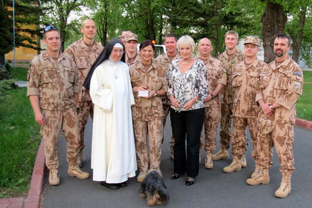 Sister Dominika, a CIMIC member, and Bela Gran Jensen in front of a group of 10th Unit of PRT advance party at the Prague-Kbely Airport before departure to Afghanistan
