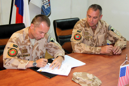 Colonel Genser signs the handover protocol