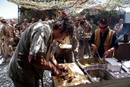 Popular Czech TV chef Jiri Babica serves grilled meat to soldiers in Logar