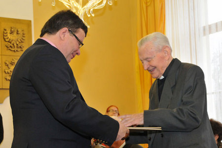 Minister Alexandr Vondra hands over the certificate to Father Frantisek Pevny for his active cooperation with a resistance group at the Jihlava region