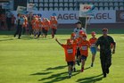 Young sportsmen accompanied by soldiers enter the stadium