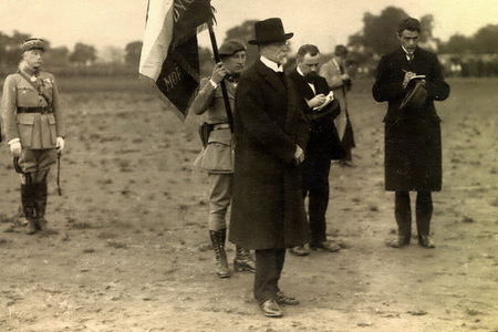 President Tomas Garrigue Masaryk at the military parade on 14 July 1919 to mark the French Day. General M. Pellé is behind the flag bearer 