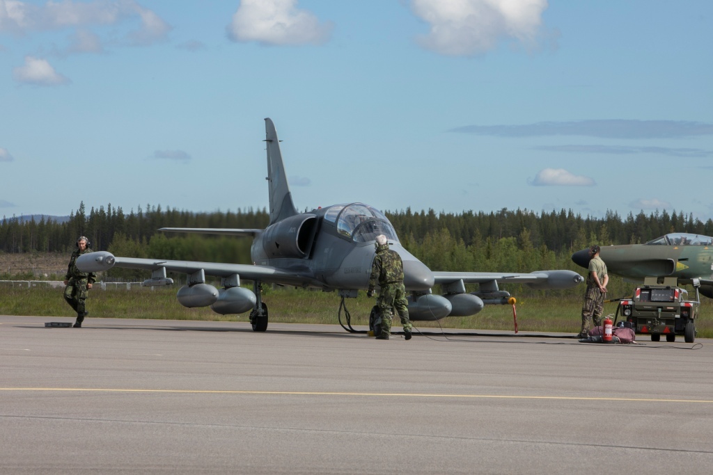 Ground personnel preparing an ALCA aircraft for a training flight