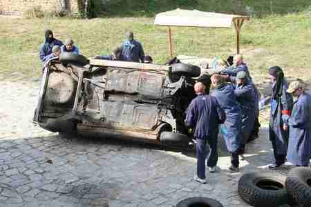 Rioting crowd overturns a car