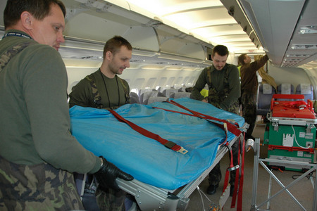 Technicians of the Kbely Airport Base attach upper part of a stretcher to the framing 