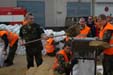 Minister helps with sandbags